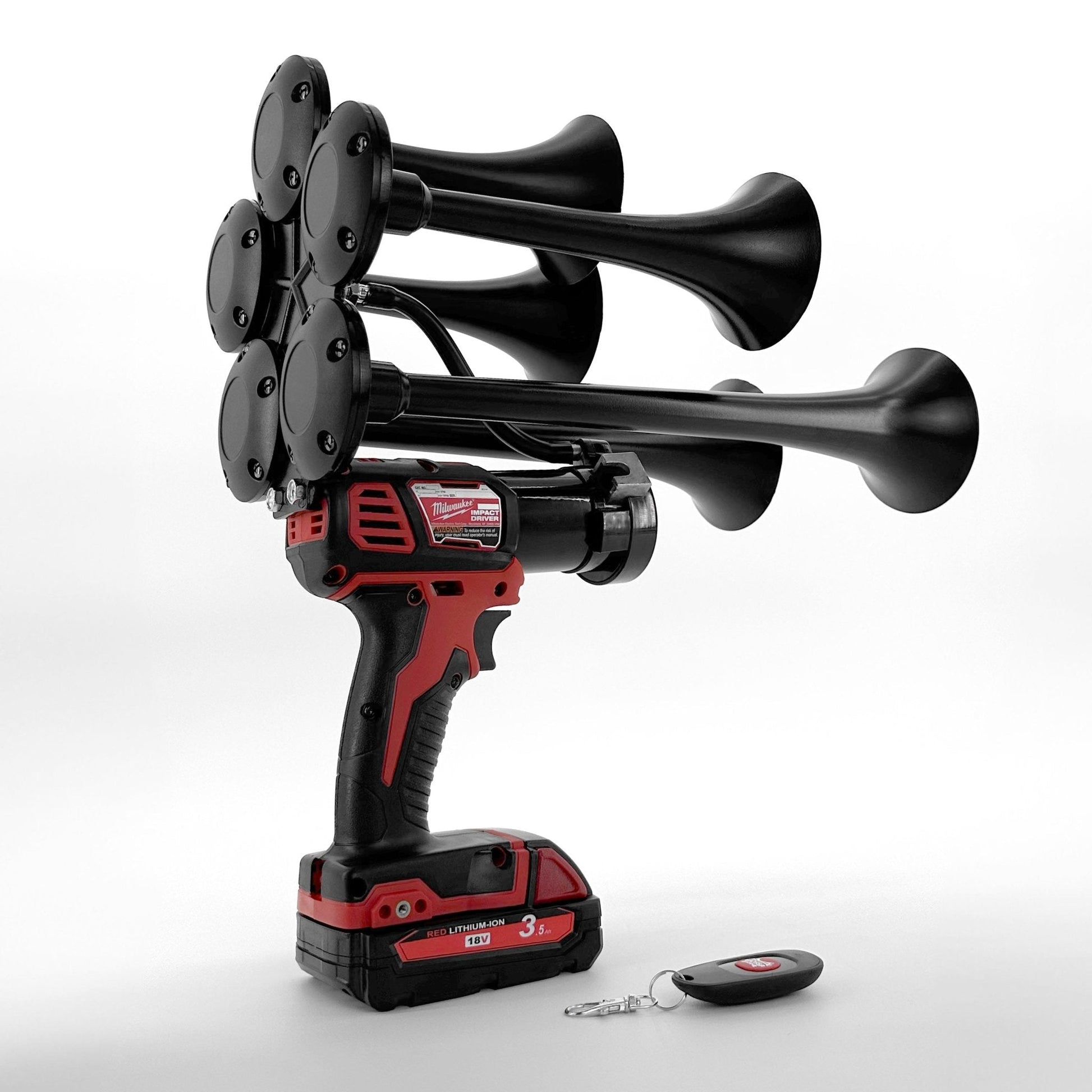 Black and red air horn with battery pack and remote control on a white background