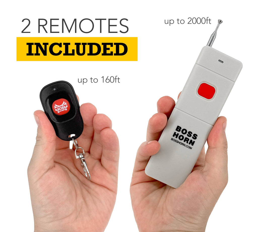 Two included wireless remotes held in hands, a compact keychain fob reaching up to 160ft and a long-range antenna remote up to 2000ft