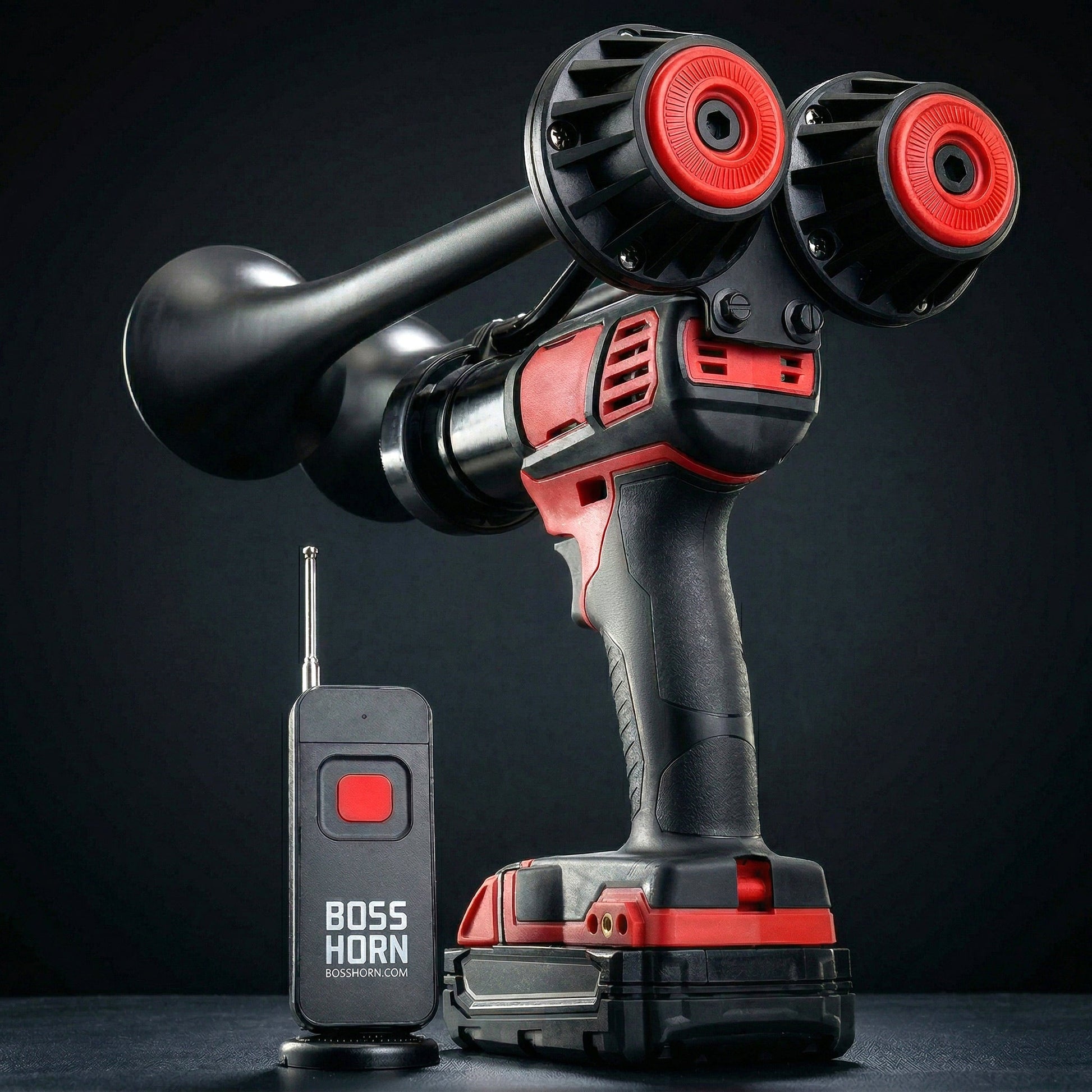 Black dual-trumpet train horn with red accents on a red cordless power tool, powered by a Milwaukee® M18 battery, beside a wireless remote
