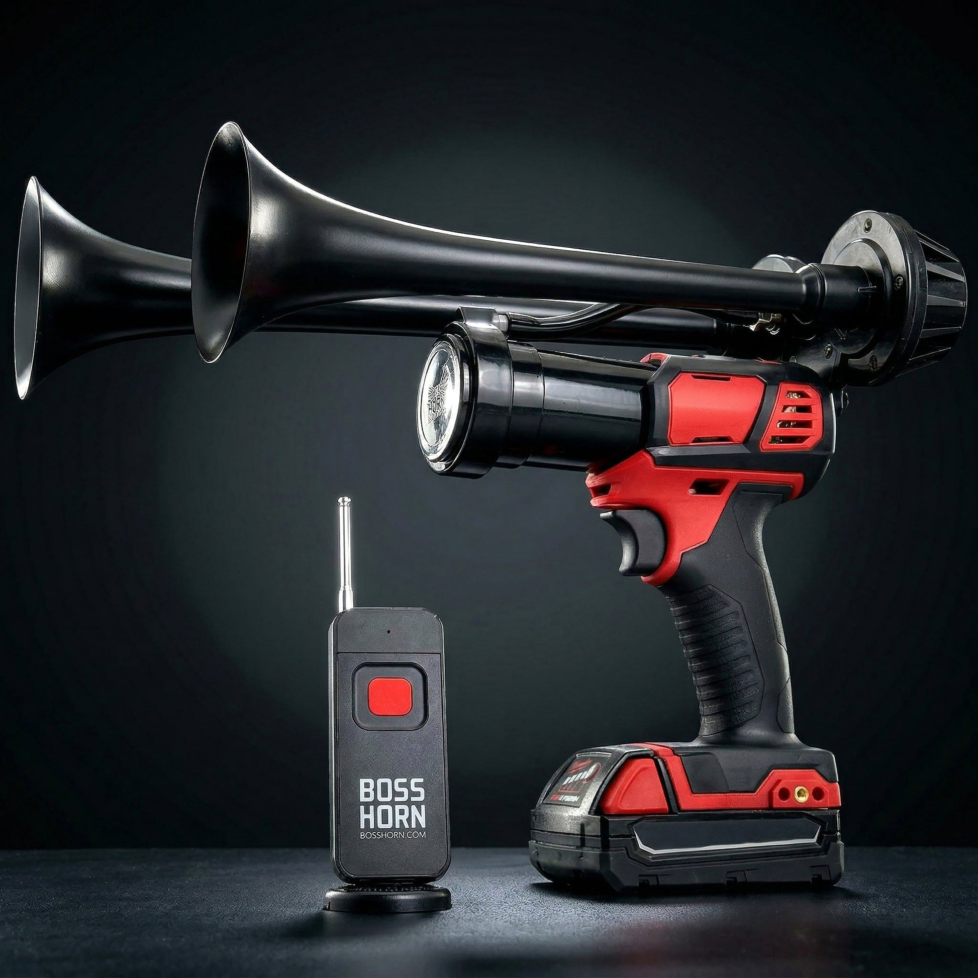 Profile of a black dual-trumpet train horn mounted on a red cordless power tool with Milwaukee® M18 battery and matching remote control