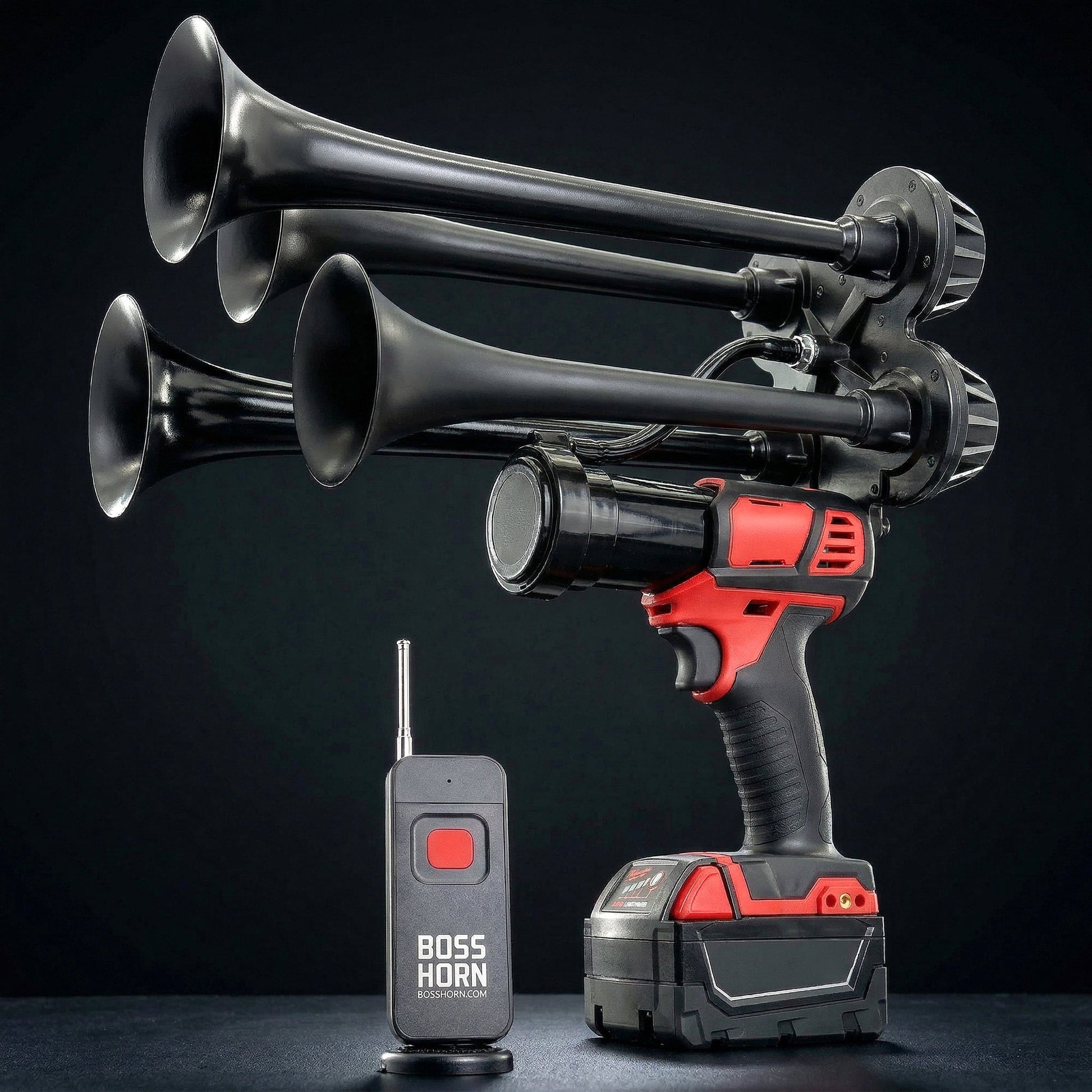 Side view of black quad-trumpet train horn with long curved bells, powered by a Milwaukee® M18 battery, next to an antenna wireless remote