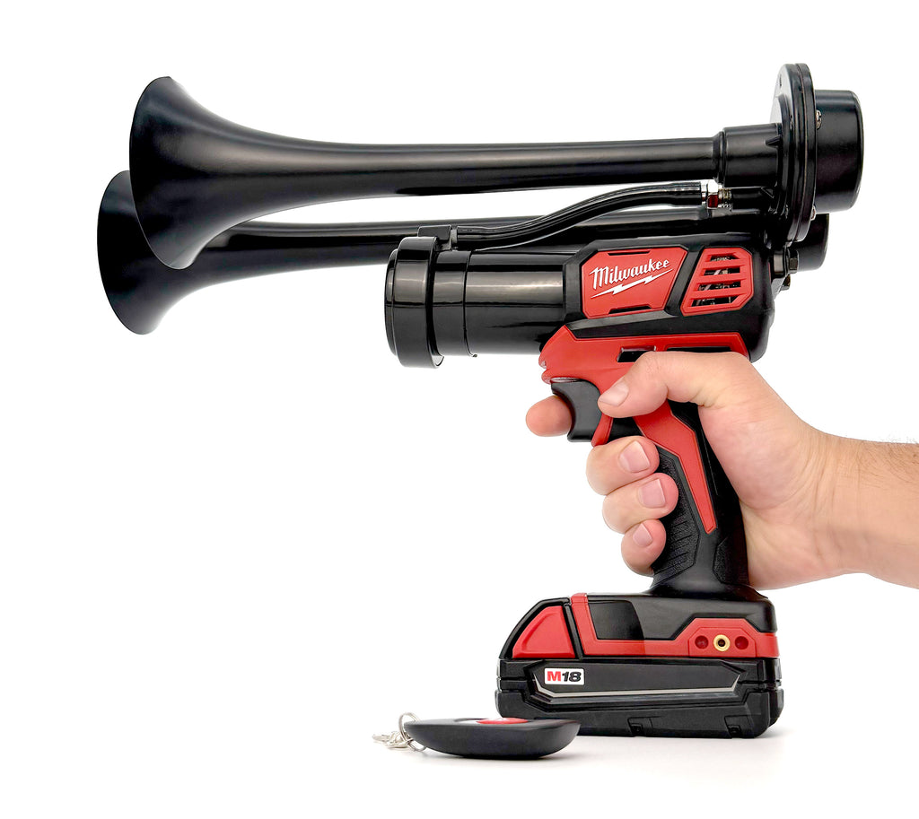 Hand holding a Milwaukee cordless air horn on a white background