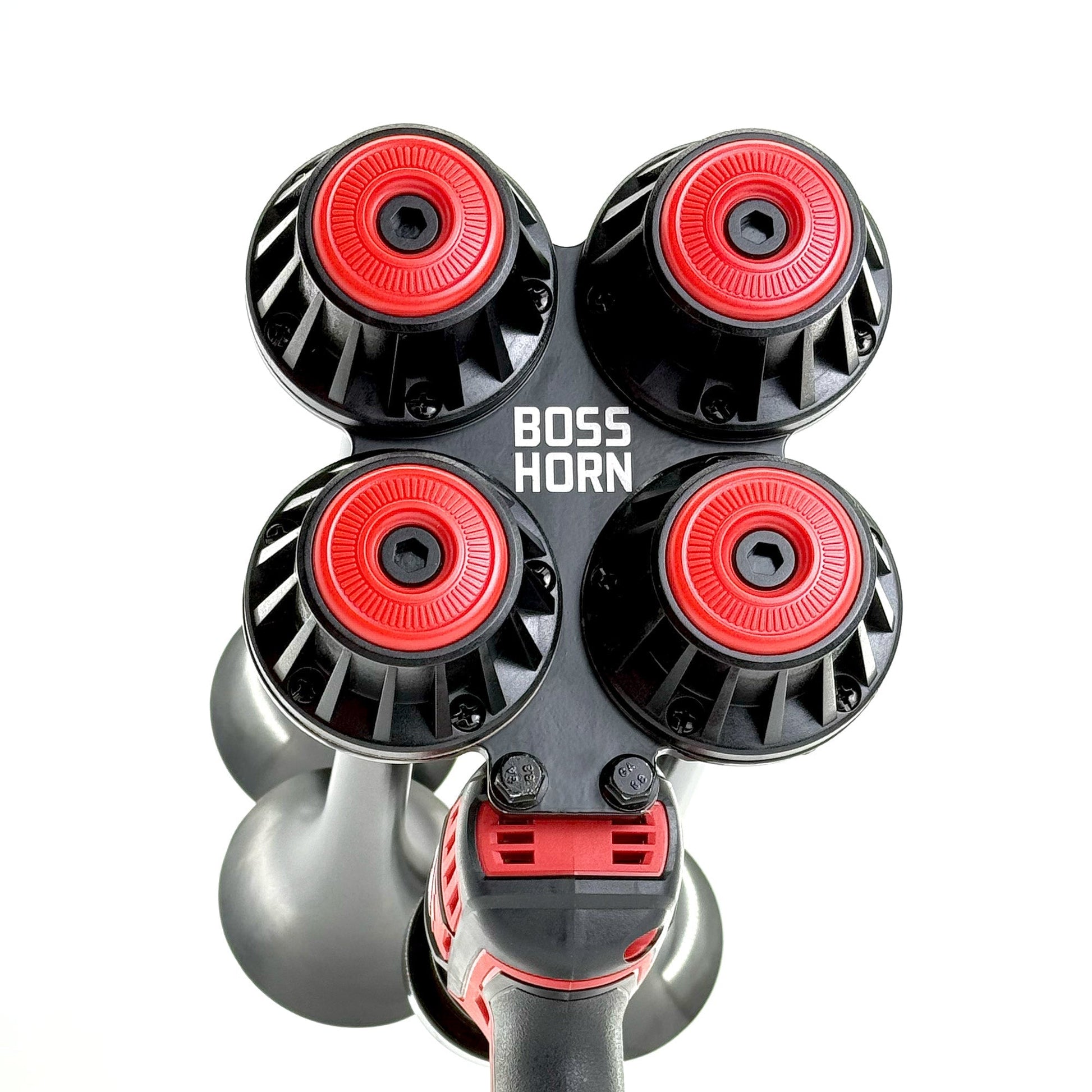 Top-down view of four black trumpets with red center caps arranged in a cluster on the horn unit against a white background