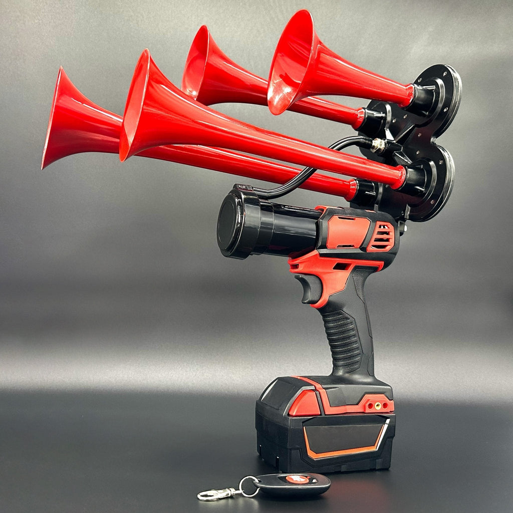 Red quad-trumpet train horn on a cordless power tool with Milwaukee® M18 battery and remote, dark studio backdrop