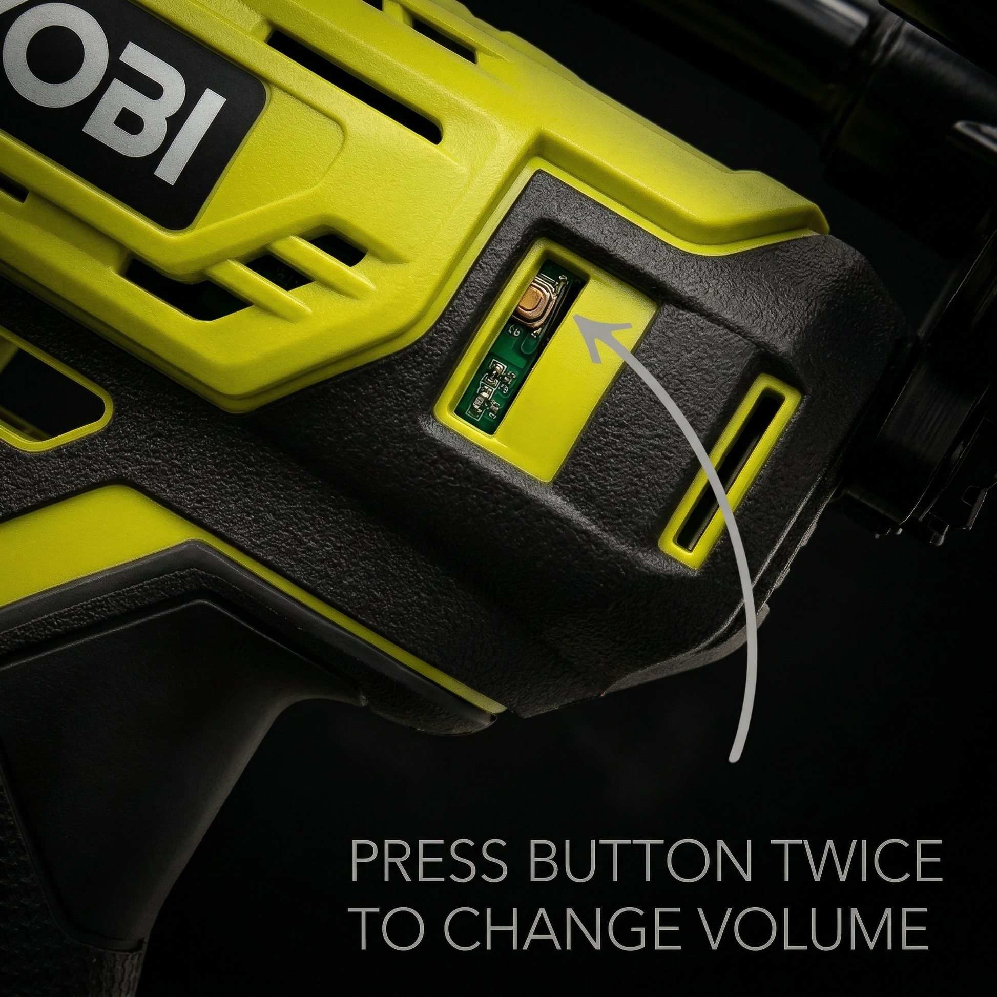 Close-up of a green and black electronic device with OBI branding and volume control instructions. dark
